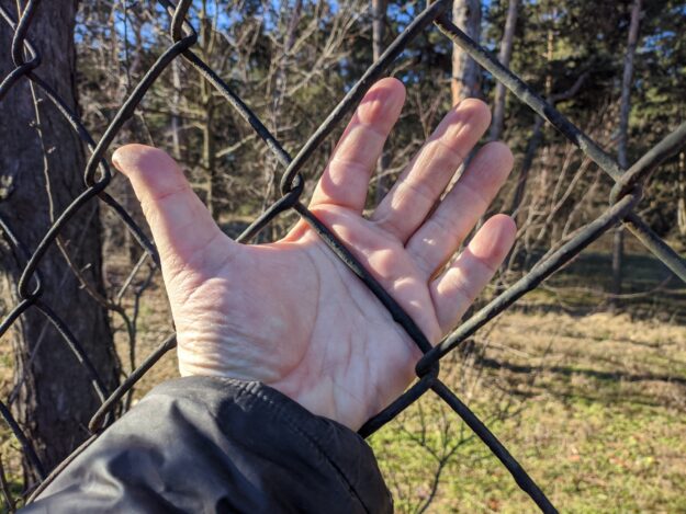Common fence mistakes with a hand on fence